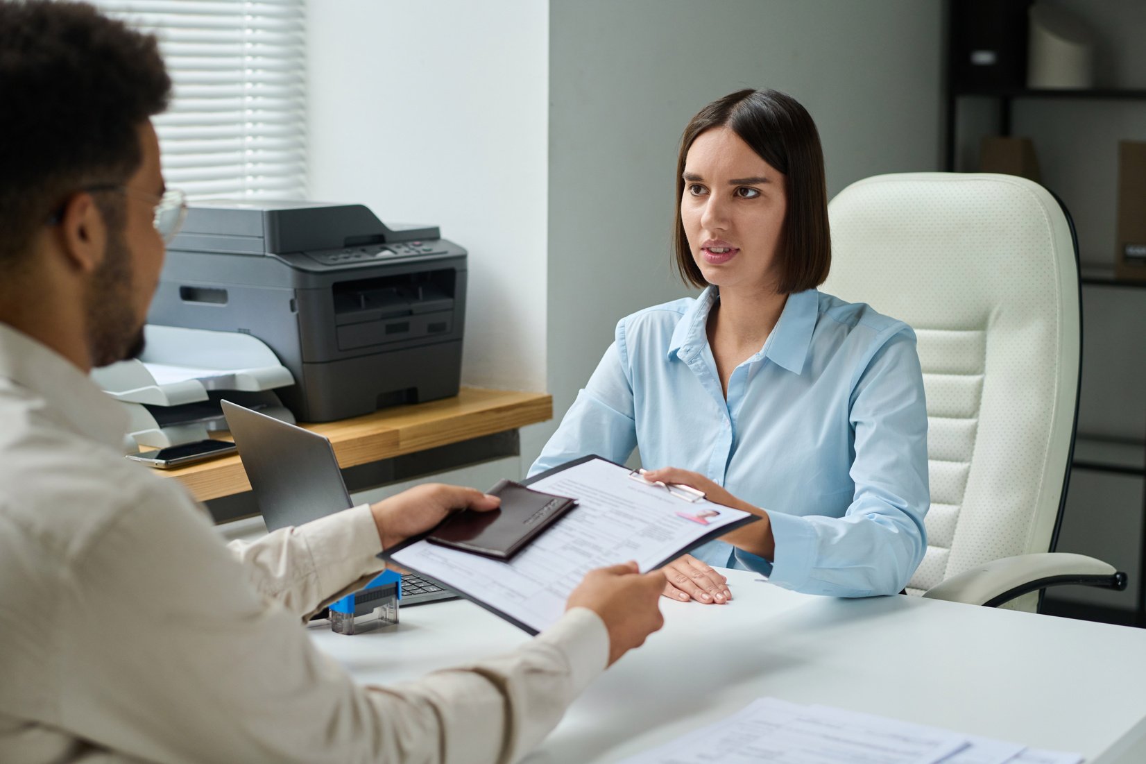 Man Giving Documents to Get Visa