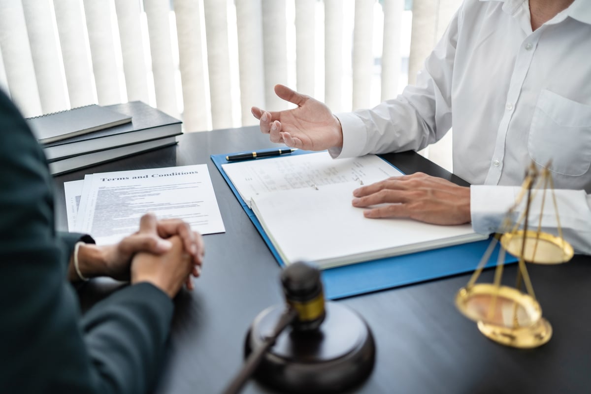 Labor law concept. Lawyer signing legal document with Judges ga