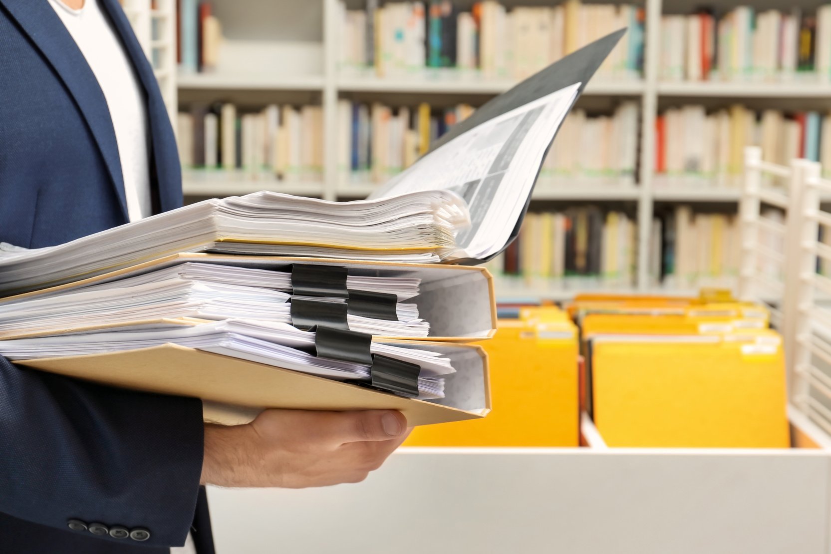 Man Searching for Documents in Archive