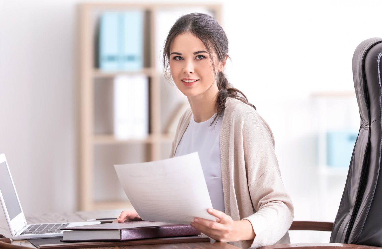 Young Female Notary Working in Office